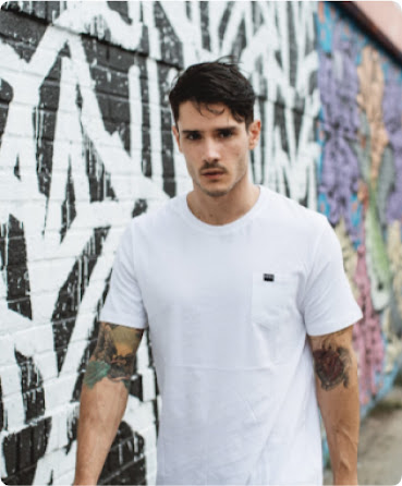 A Diesel model walking down the street with graffiti wall in the background.